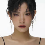 A two-piece pearl chain asymmetric rhinestone tassel long earring