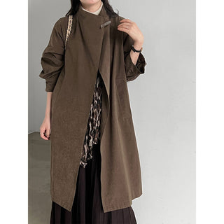 Black stand-collar longline trench coat styled with ivory wide-leg trousers