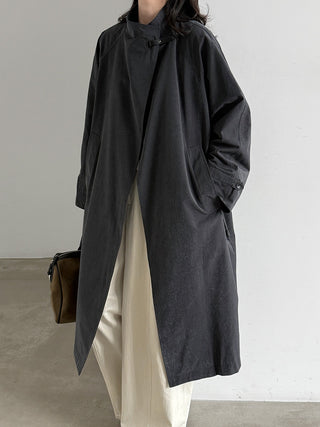 Black stand-collar trench coat showing relaxed silhouette on model