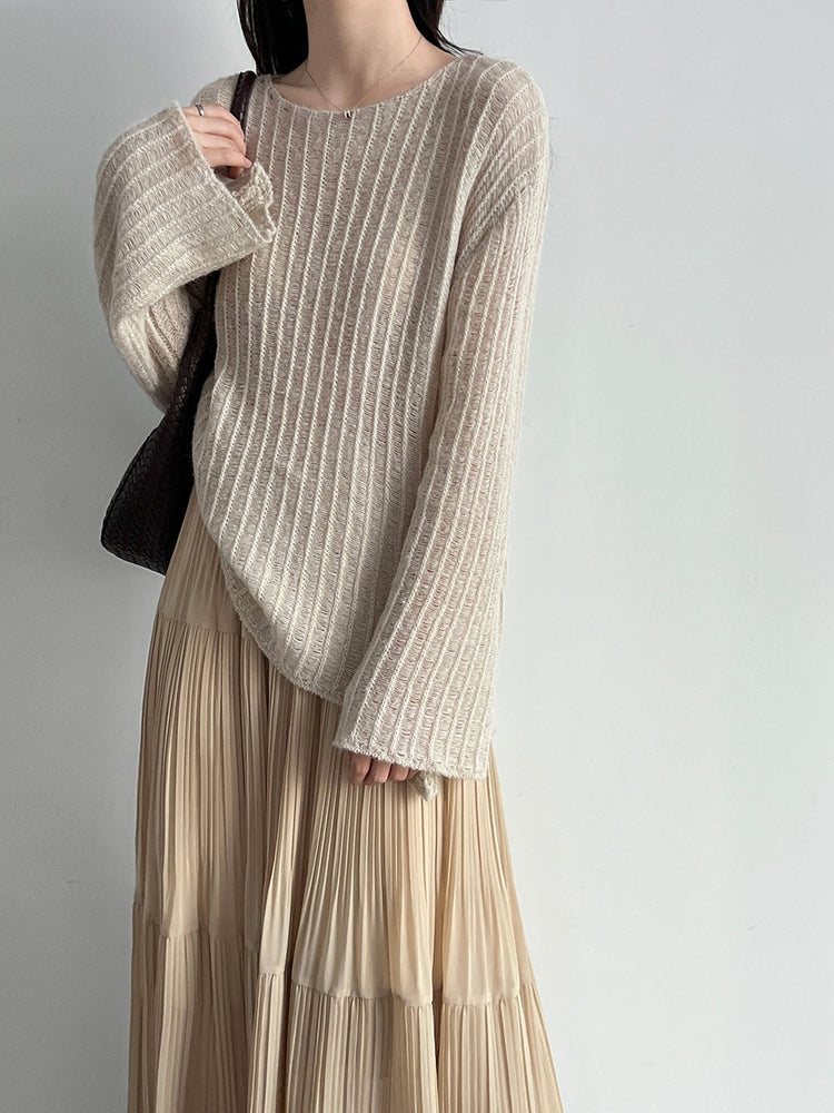 Back view of the beige textured knit top with long sleeves; skirt shown for styling only.