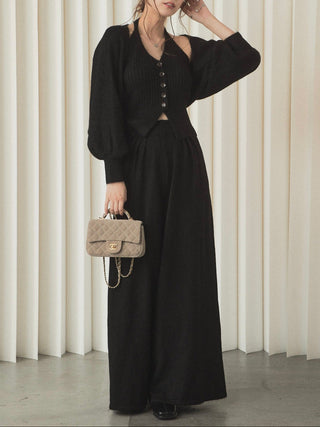 Front view of a model wearing a gray three-piece knit set with relaxed wide-leg trousers