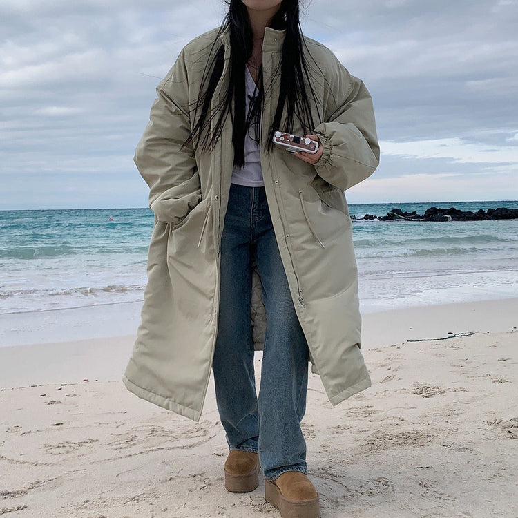 Light khaki longline parka with side pockets and gathered cuffs