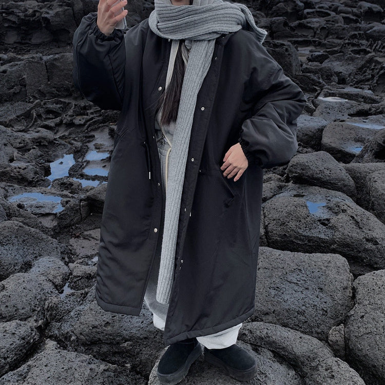 Black longline parka styled with a grey scarf, scarf not included