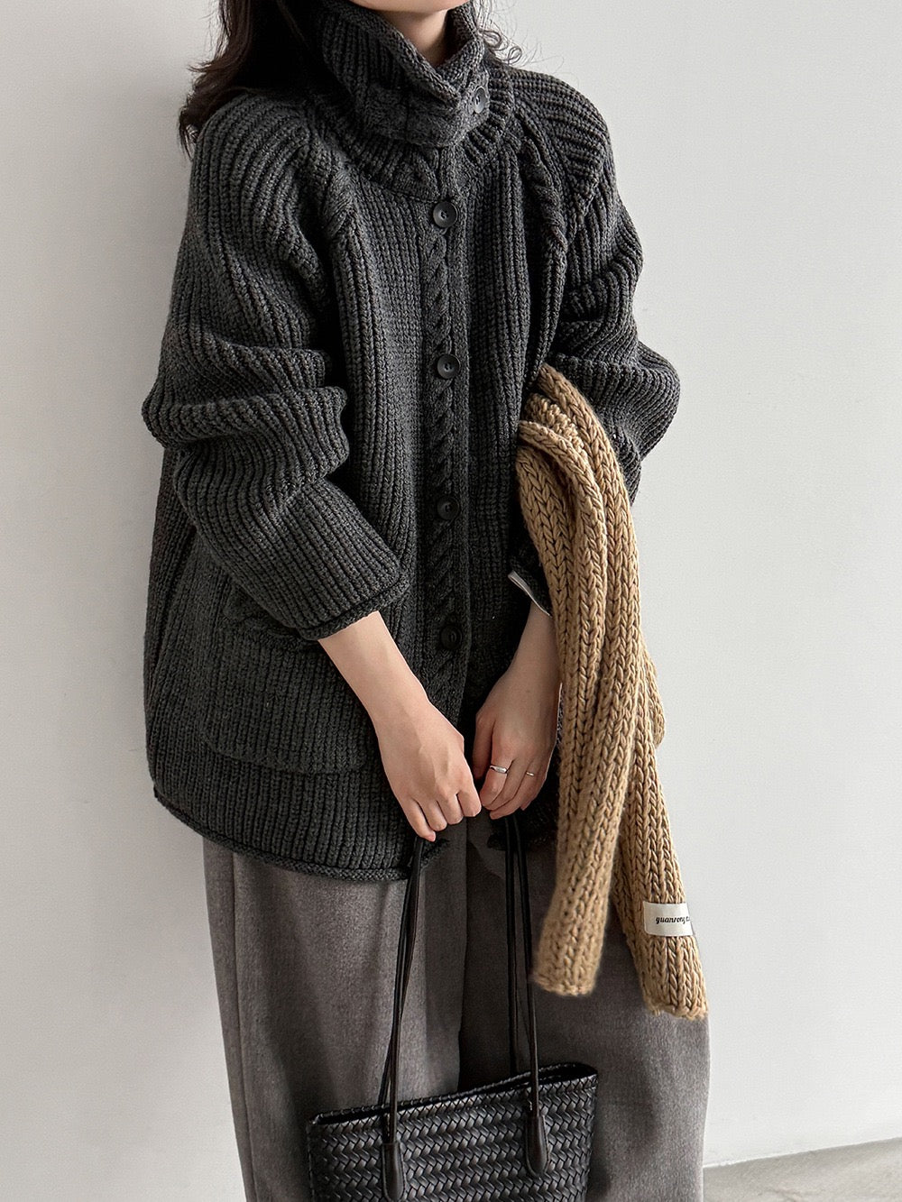 Charcoal button-front cable knit cardigan styled with grey trousers