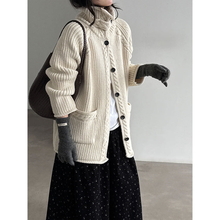 Ivory cable knit cardigan, angled view showing pocket and collar