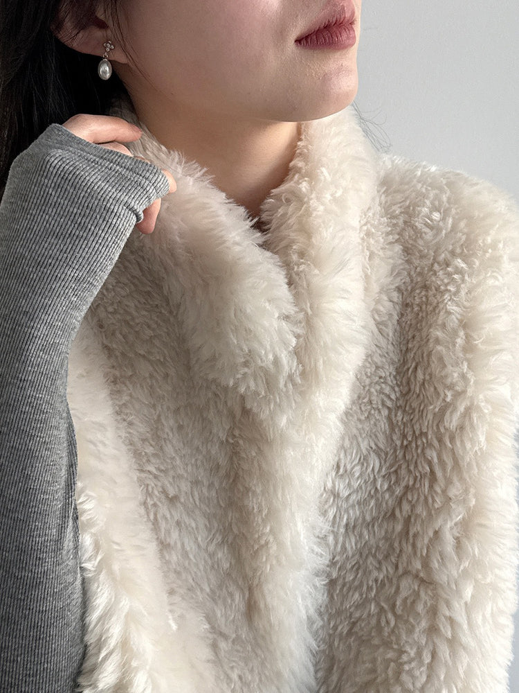 Close-up of the ivory vest collar and curly plush texture