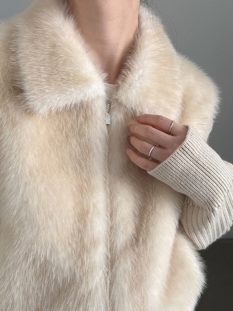 Close-up of the ivory jacket collar, textured front and zip fastening
