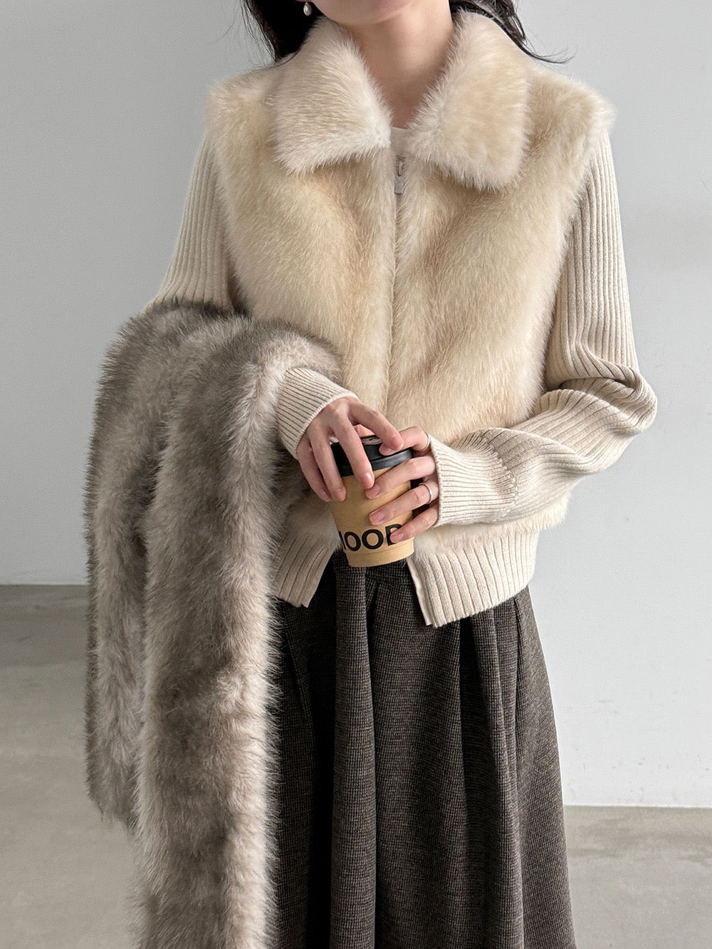 Ivory cropped knit jacket styled with a dark skirt